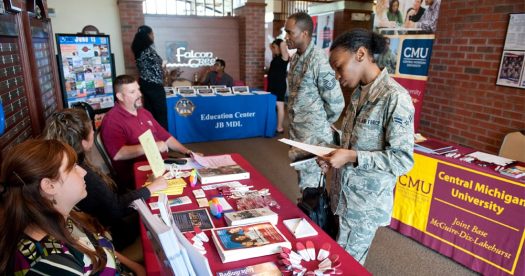 Service members looking at brochures for universities