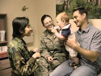 Military counselor with young boy and family