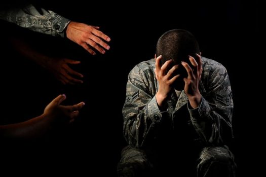 Hands reaching out to suffering service member