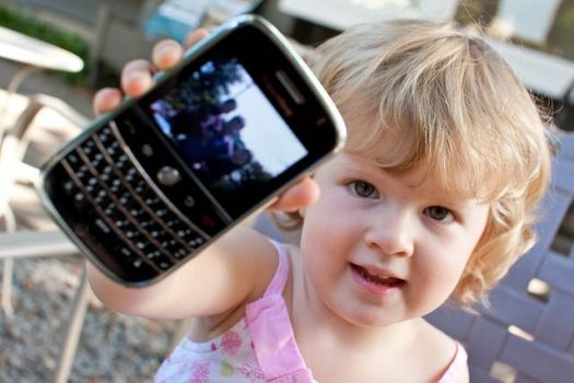 Child holding a cell phone