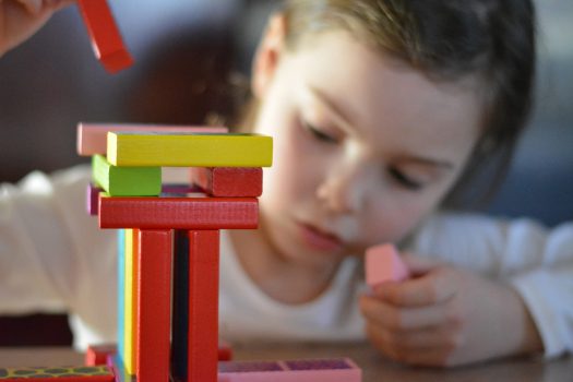 young girl building with blocks
