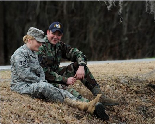 Dual military couple sitting talking