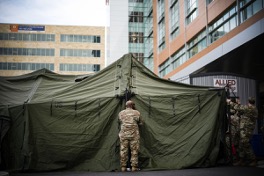 Soldier setting up tent
