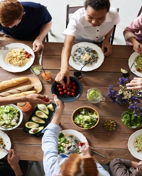 People sitting at a table dining on healthy foods