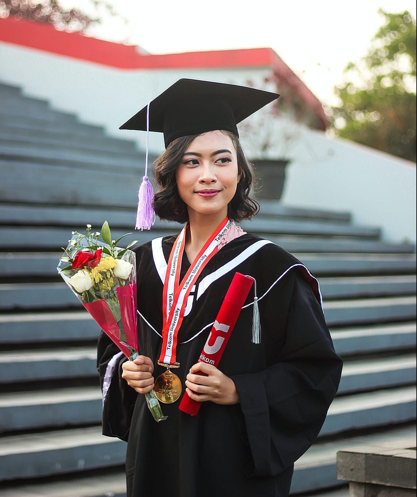 Young woman in graduate gown and mortar board.