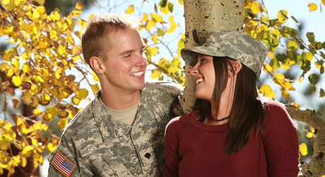 Military couple smiling at each other.