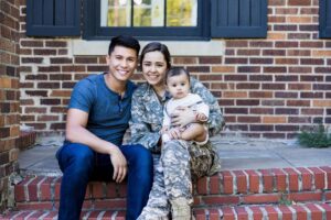 Female service member with her spouse and baby