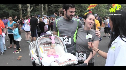 Marathon runner couple with baby being interviewed