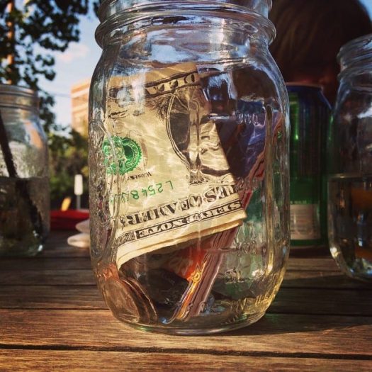 Jar of spare change and dollar bills
