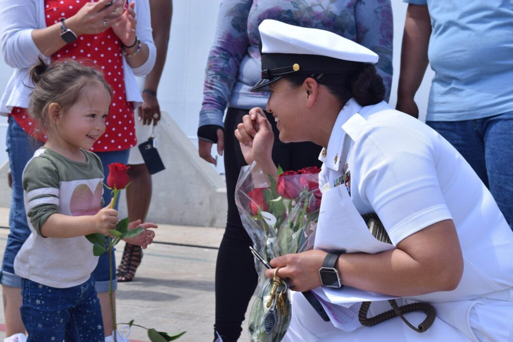 Navy Officer greeting her young daughter.