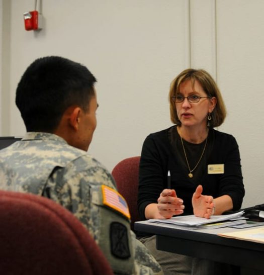 A photograph of Lori Mann (right) an Army Career and Alumni Program counselor offers career guidance to a Soldier at the ACAP center at Joint Base Lewis-McChord, Wash.