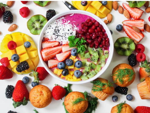 Healthy foods including fruit, yogurt, and muffins
