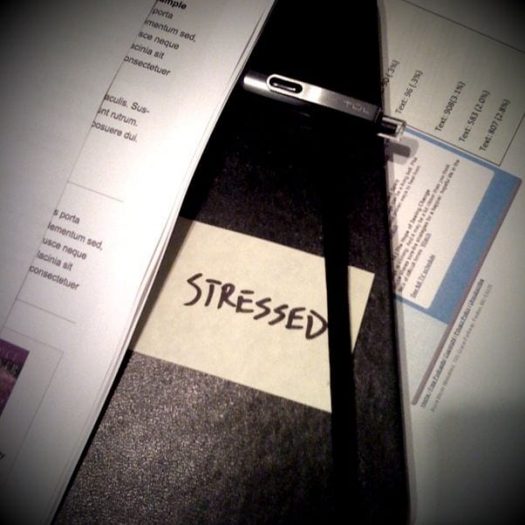 sticky note on a desk with the words "Work Stress" written on it