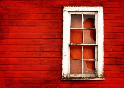 Broken window on red house