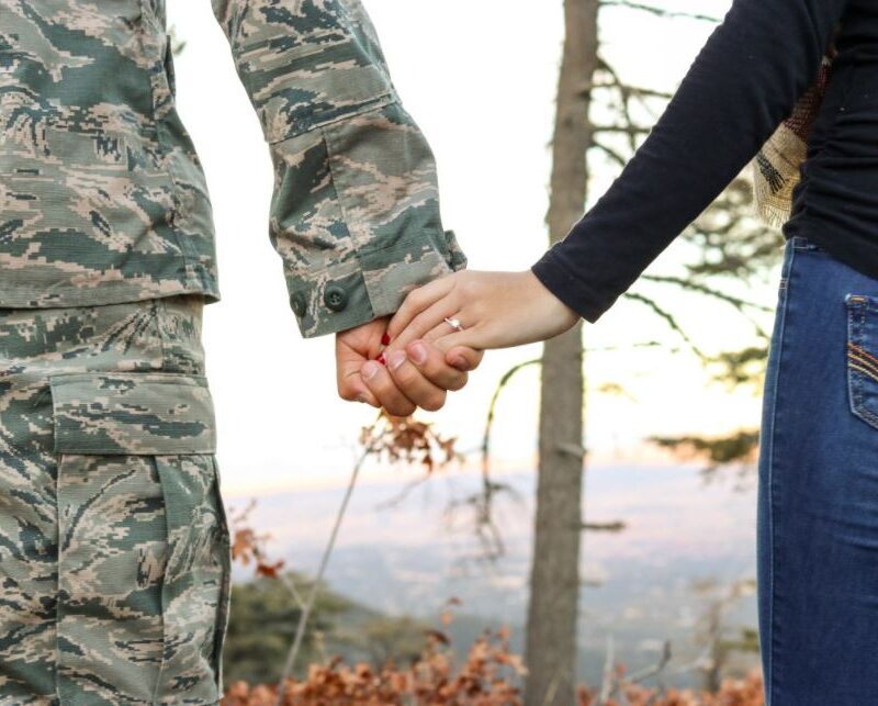 Hand holding military couple