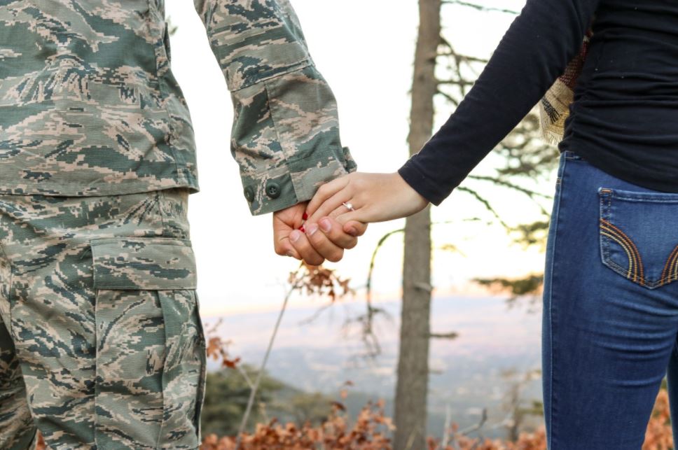 Hand holding military couple