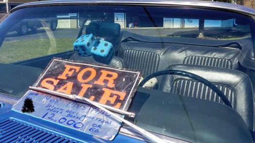 Convertible car with a For Sale sign in the window