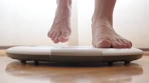 image of feet Stepping onto a scale