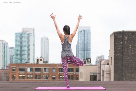 woman doing yoga on rooftop