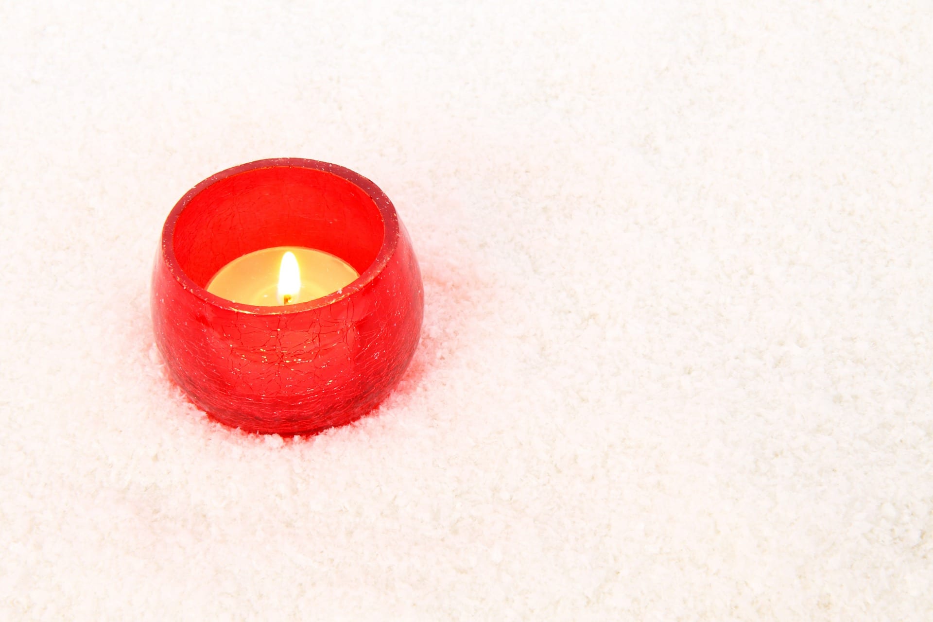 image of candle in the snow