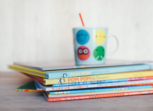 Childrens Books with colorful mug on top