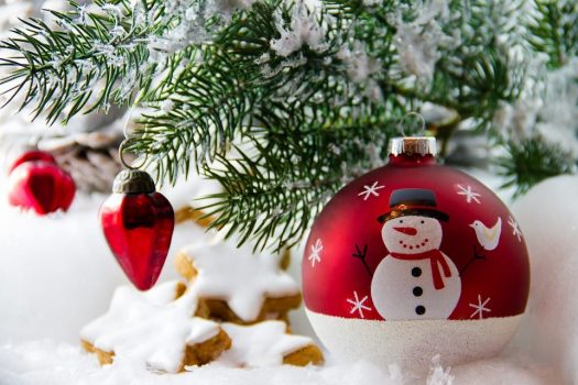 Christmas ornament with a snowman under Christmas tree