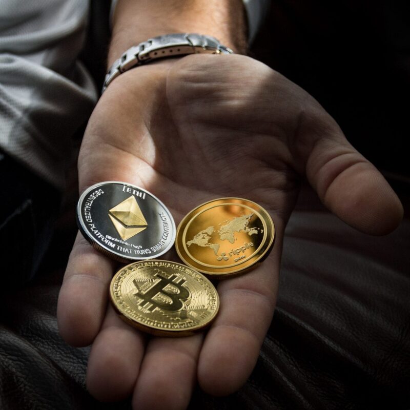 Hand with cryptocurrency coins