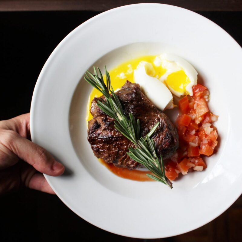 steak, eggs and vegetables on a plate