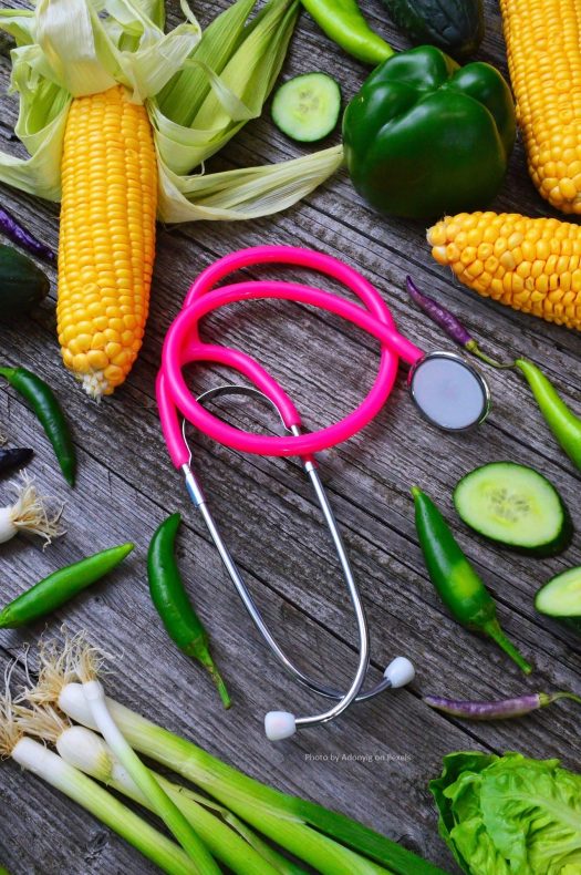 Stethoscope lying in the middle of assorted vegetables