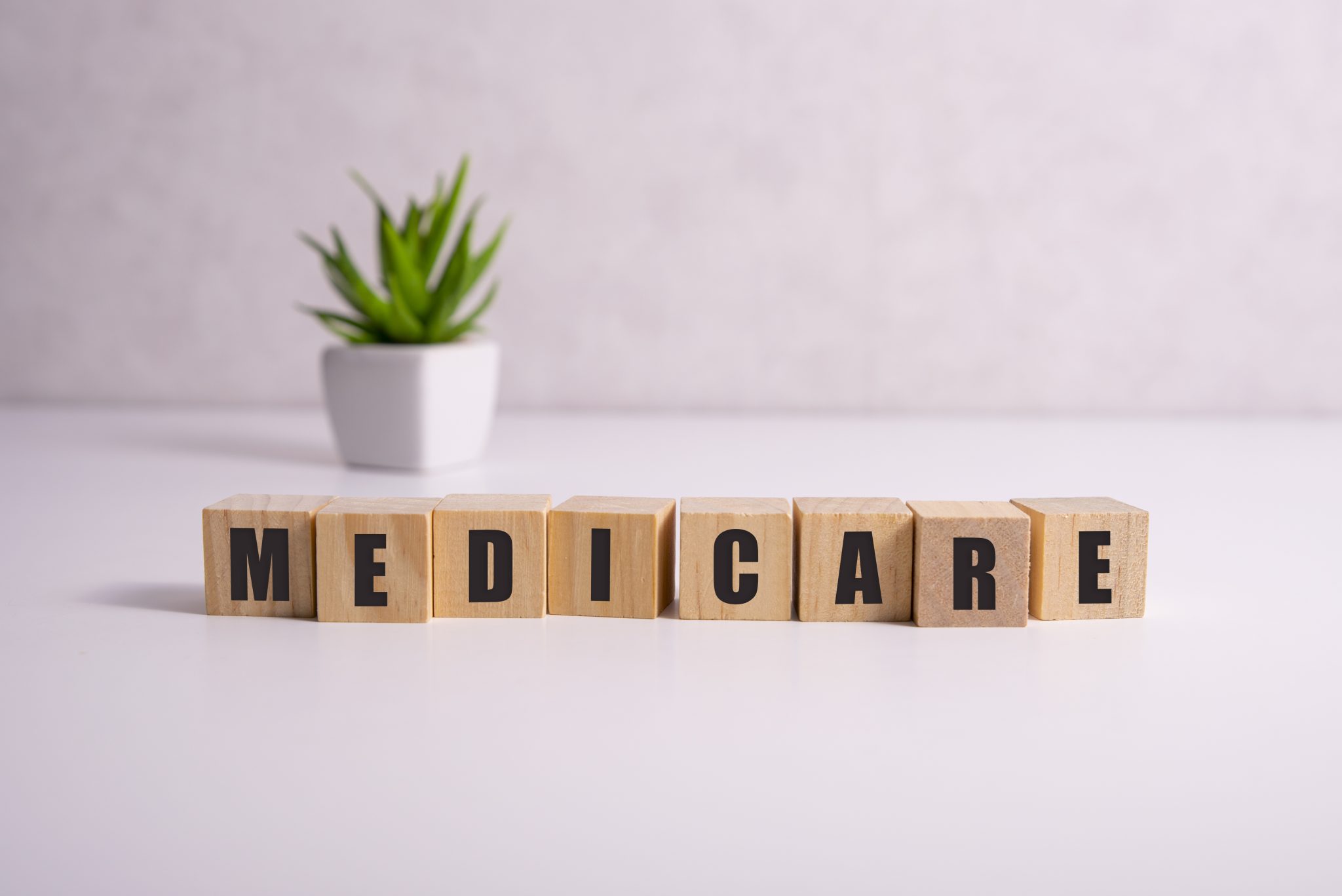 MEDICARE word made with building blocks, medical concept background.