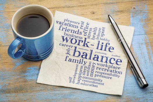 work life balance word cloud on a napkin surrounded by coffee and a pen