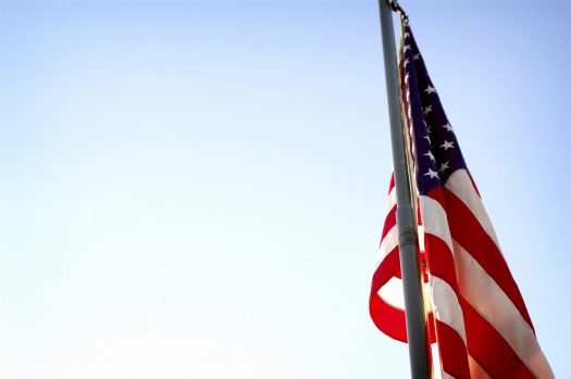 American flag with blue sky in the background