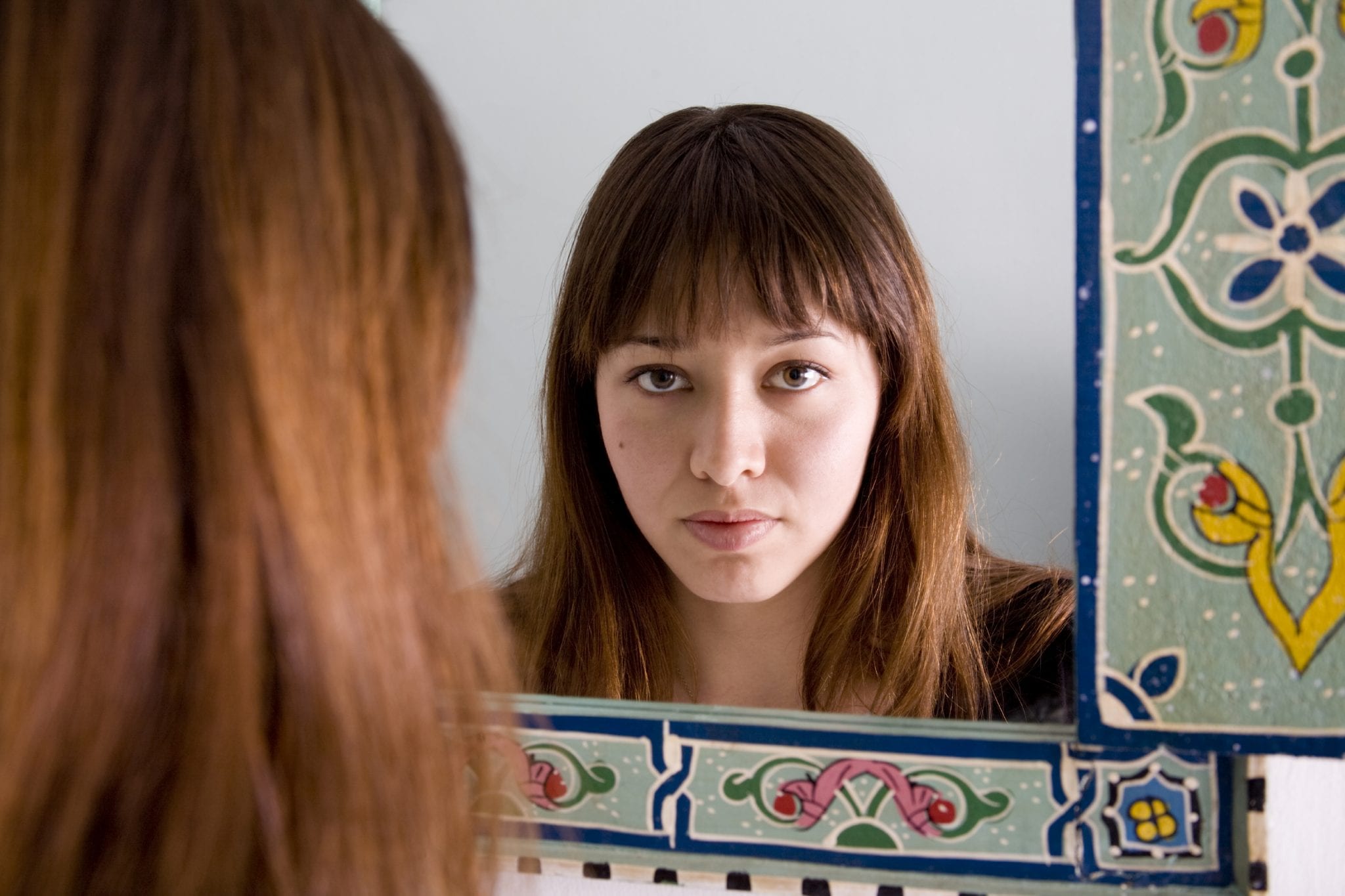 Women in front of mirror