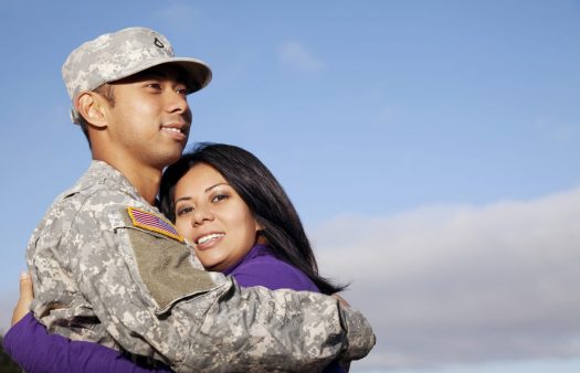 Man in military uniform and woman embracing