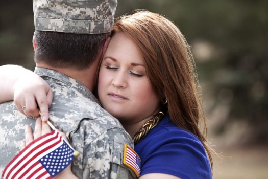 Woman embracing service member