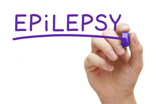 Hand writing "epilepsy" with purple marker