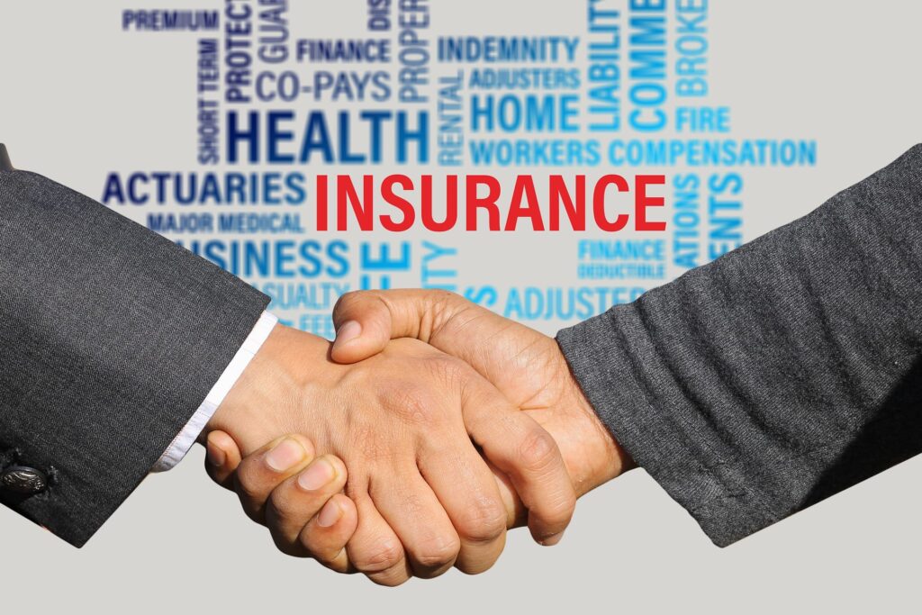 Men shaking hands in front of words about insurance