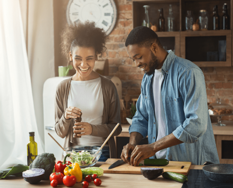 man and woman in kitchen cooking