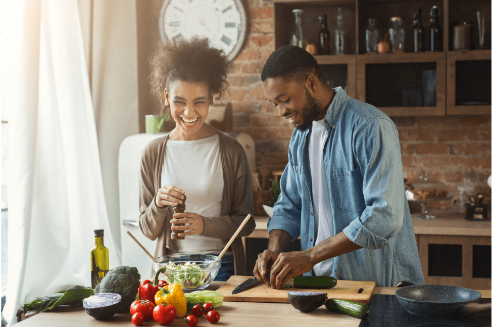 man and woman in kitchen cooking