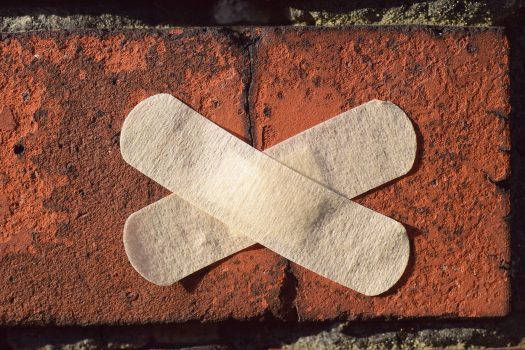 Band-aid patches on a brick