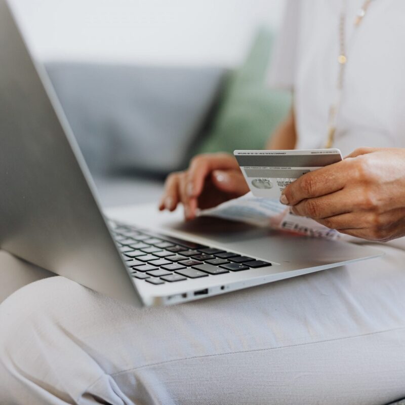 Woman holding laptop and credit card