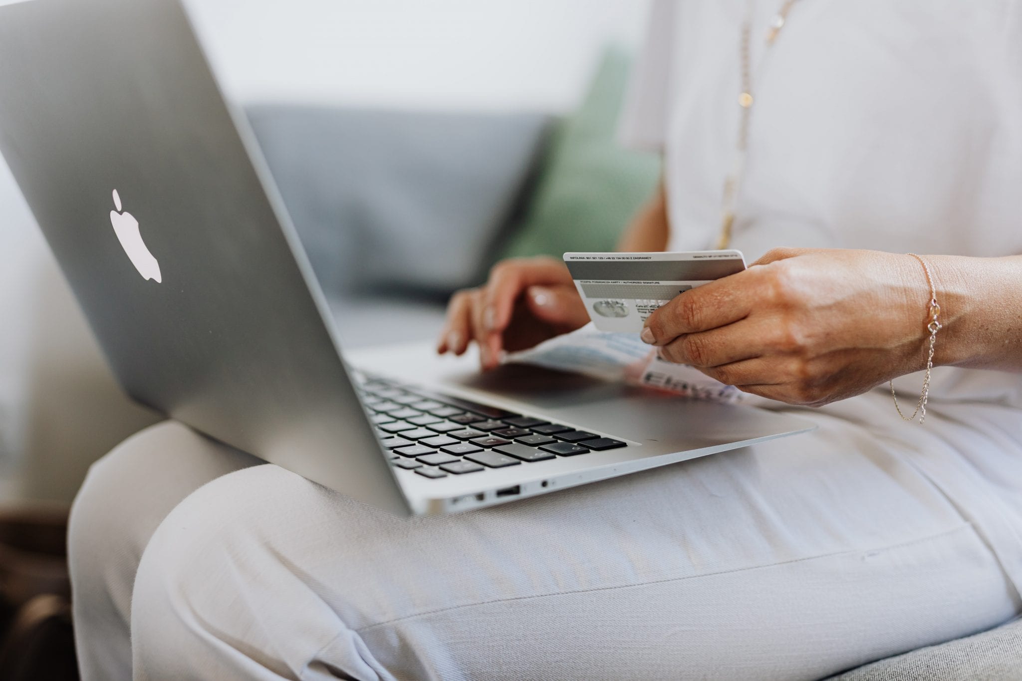 Woman holding laptop and credit card