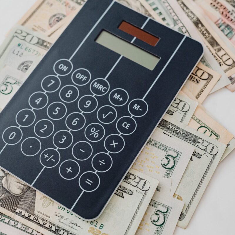 Calculator laying on top of cash