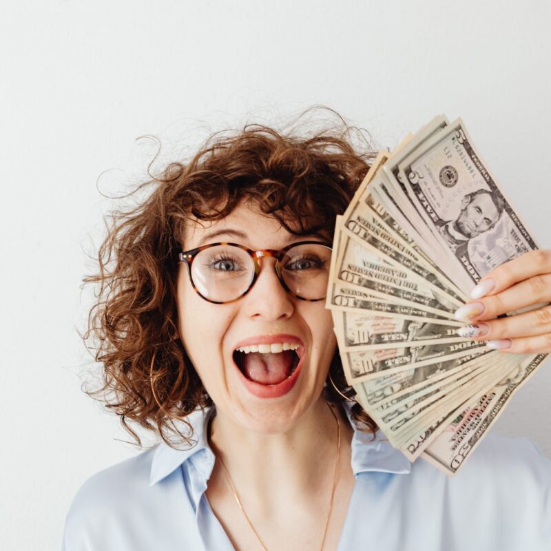 Smiling woman holding cash
