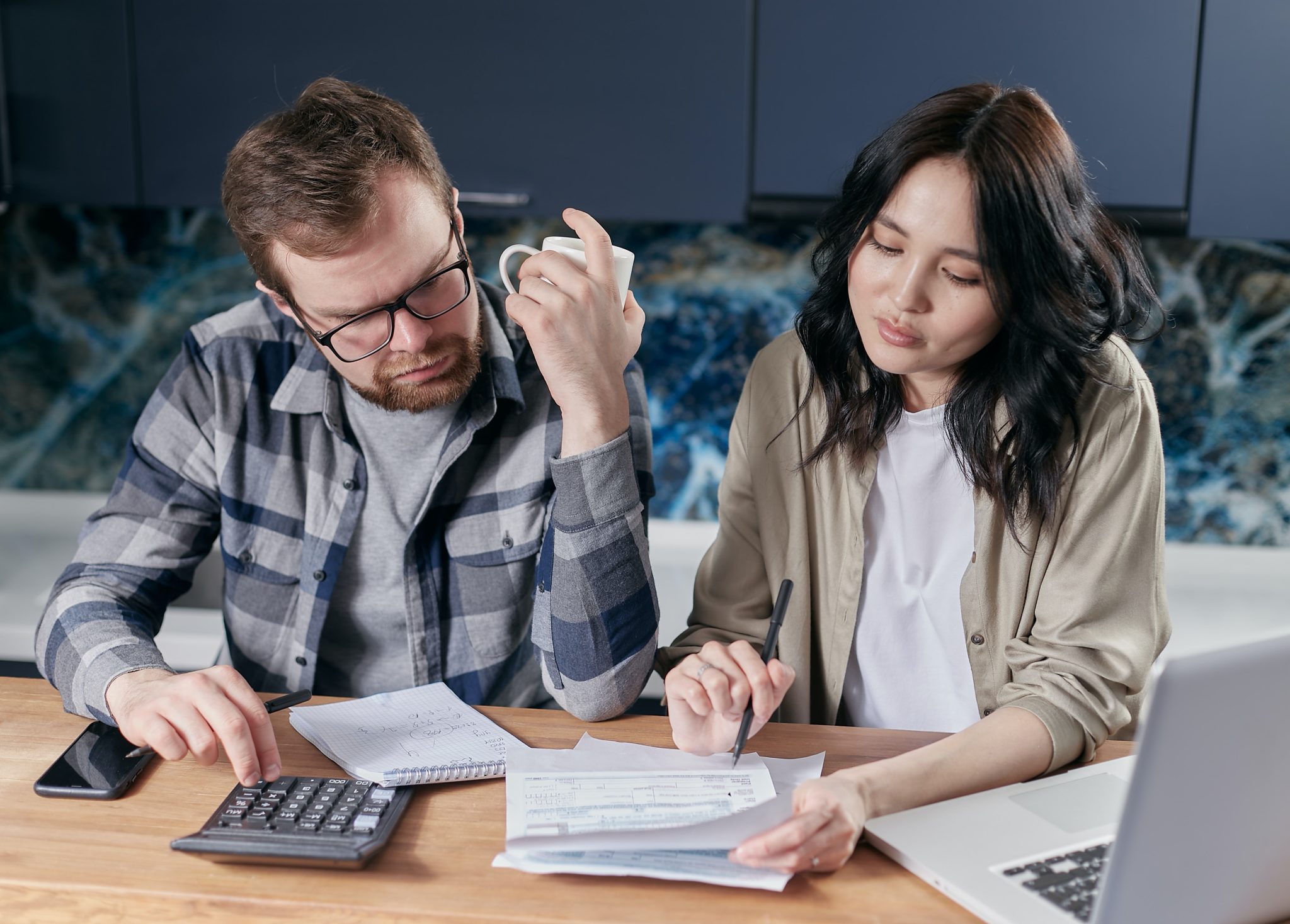 two people budgeting and using a calculator