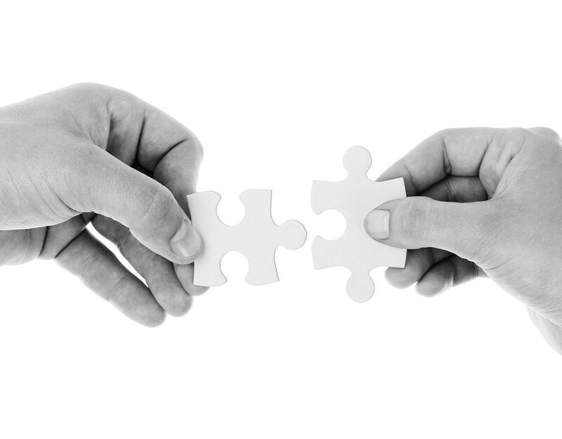 Picture of hands putting two puzzle pieces together