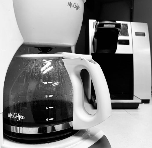 a drip coffee maker and a keurig in the background