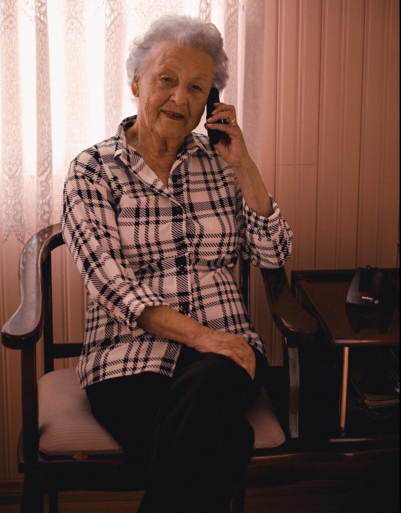 Woman sitting in a char talking on a phone