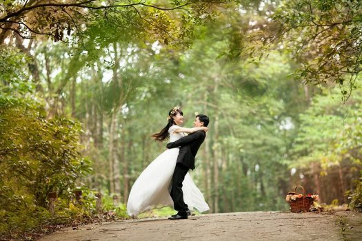 Newly married couple embracing on trail outside