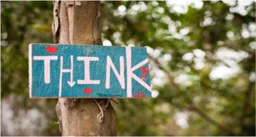Sign on tree trunk saying, "Think"